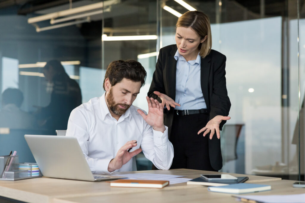 Employee having conflict with angry female boss in office
